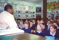 Children sit for hours in a crowded classroom.